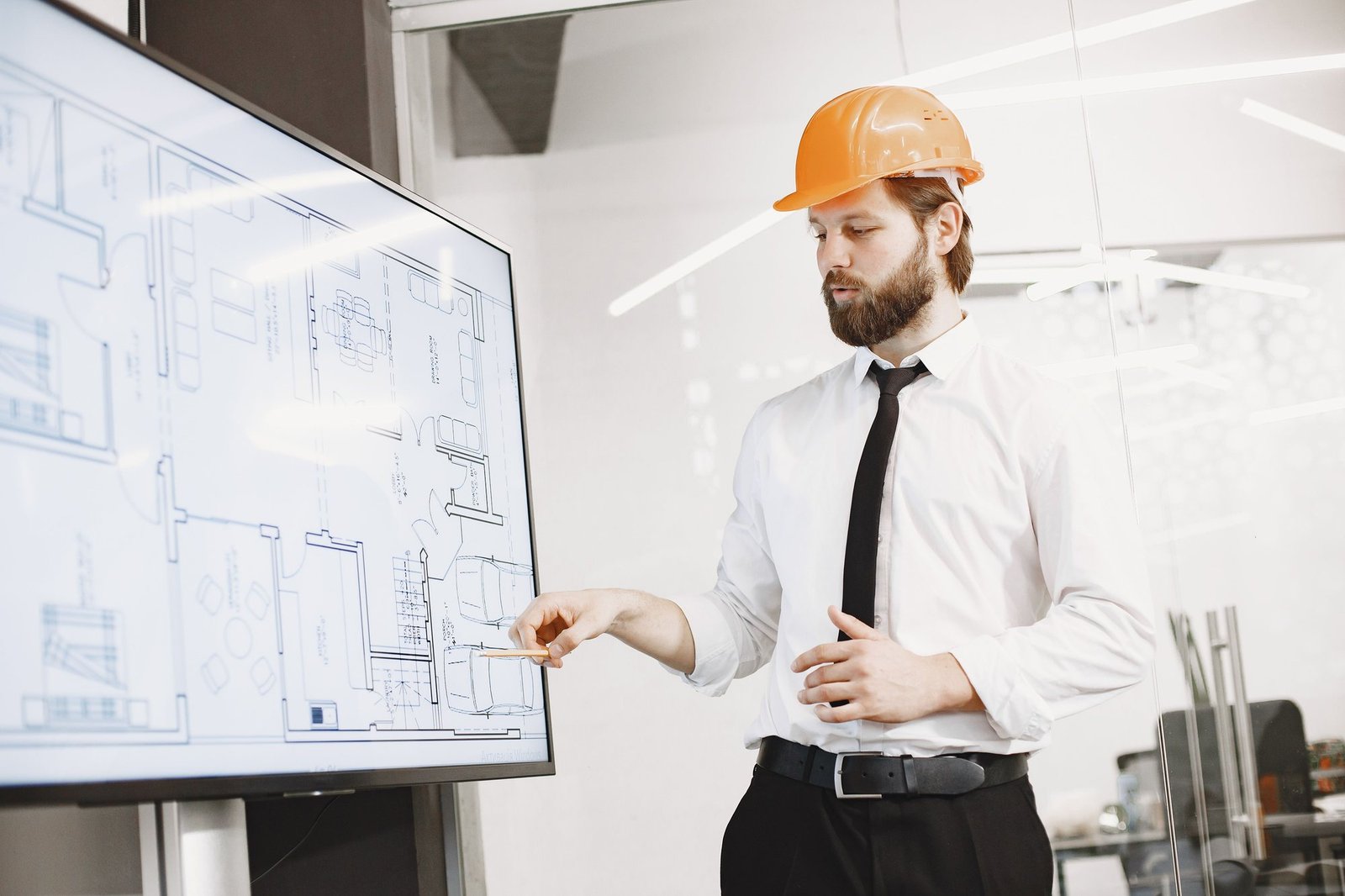 Construction professional reviewing technical drawings